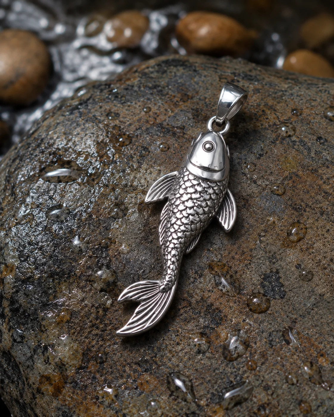 Detailed koi fish pendant showing the fish swimming upstream โ symbol of perseverance, determination and transformation